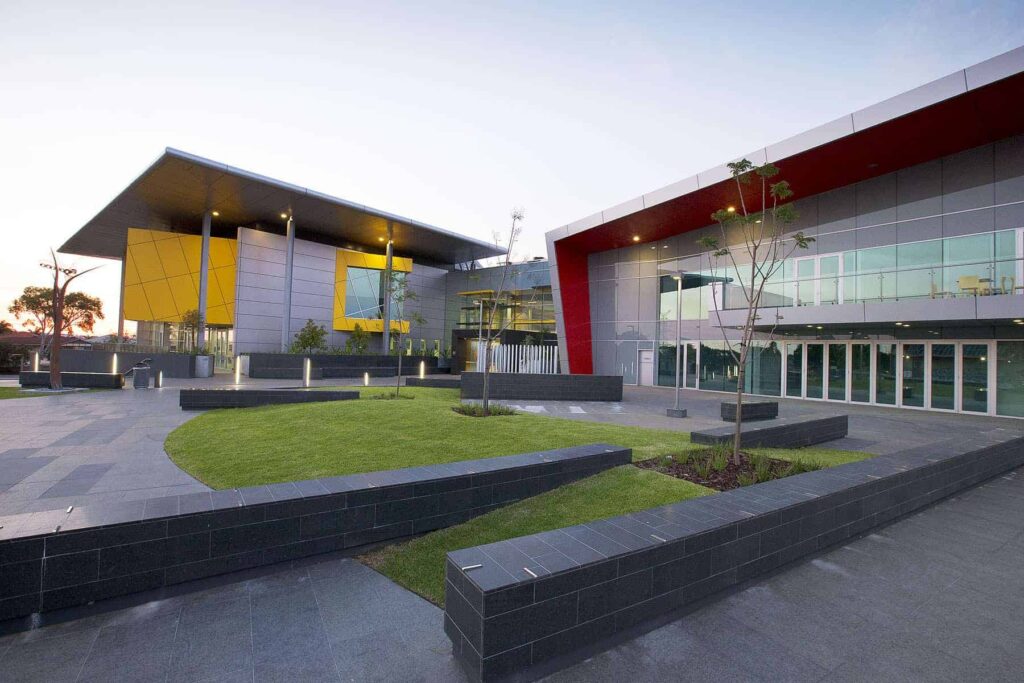 A modern building with a red and yellow facade.