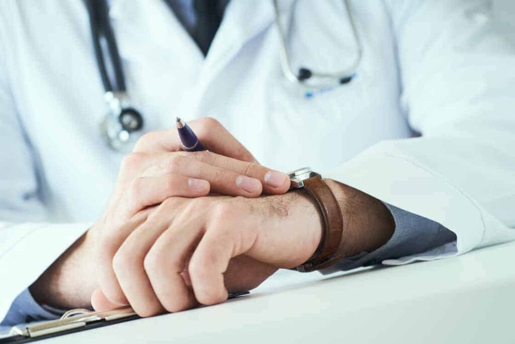A doctor's wrist with a pen on it.