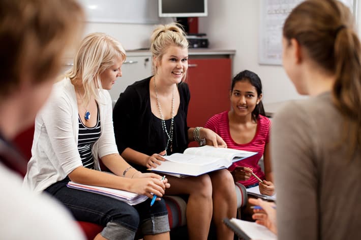 A group of students sitting in a classroom.